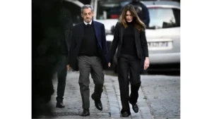 Nicolas Sarkozy, with his wife, Carla Bruni, leaves his residence to present himself at La Santé prison. Photograph: Julien de Rosa/AFP/Getty Images