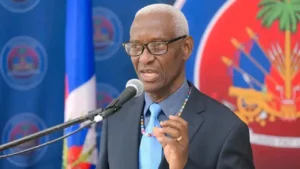 Joseph André Gracien Jean, ministre délégué chargé des questions électorales et constitutionnelles, s'exprimant lors des Mardis de la Nation le 3 février 2026. (Photo publiée par @PrimatureHT)