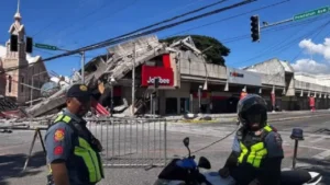 La police se rassemble devant un restaurant Jollibee effondré après un séisme de magnitude 7,8, à General Santos, aux Philippines, lundi 8 juin 2026. © Edwin Espejo, AFP